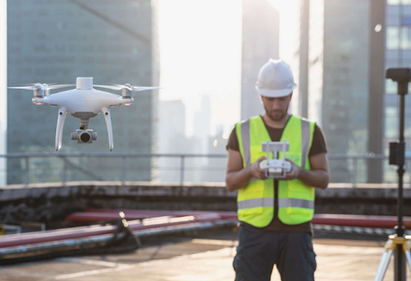 drone pilot controlling the DJI Phantom 4 RTK drone with the controller